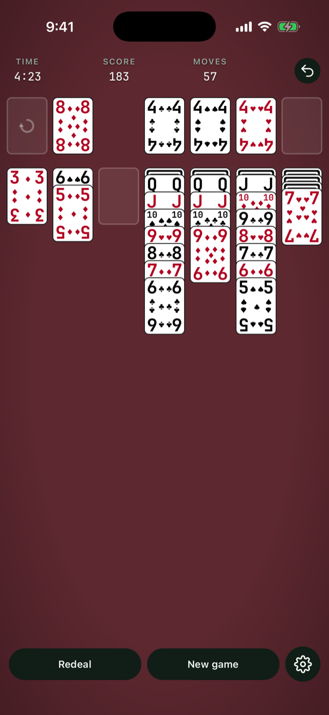 A mid game with the Large print deck on the crimson table, long built runs and the stock recycled